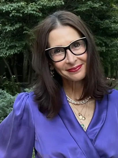 A woman in glasses and a blue shirt